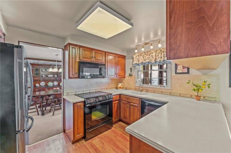 The Kitchen features a combination of stainless steel and onyx appliances, ceramic tile backsplash and is open to the eating area.