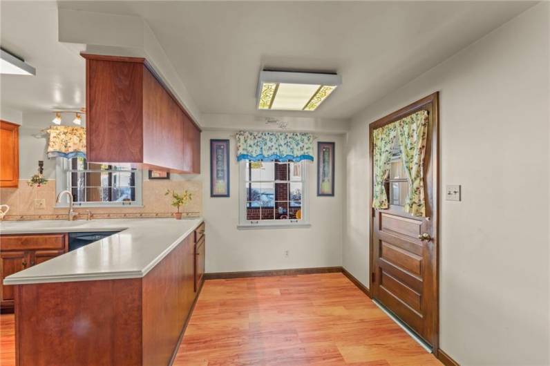 The dining area in the Kitchen is quaint and has a door leading to the Sun Room!