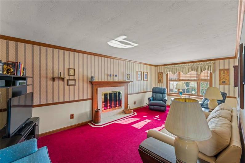 The Family Room is perfect for large gatherings with friends and loved ones.  This room features a gas burning fireplace with custom mantel, crown moldings, chair rail and large Bay window.