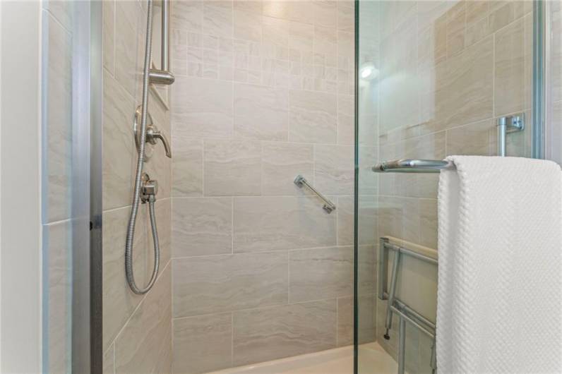 The Master Bathroom shower is ceramic tiled and has rain shower head and built in bench and grab bars.