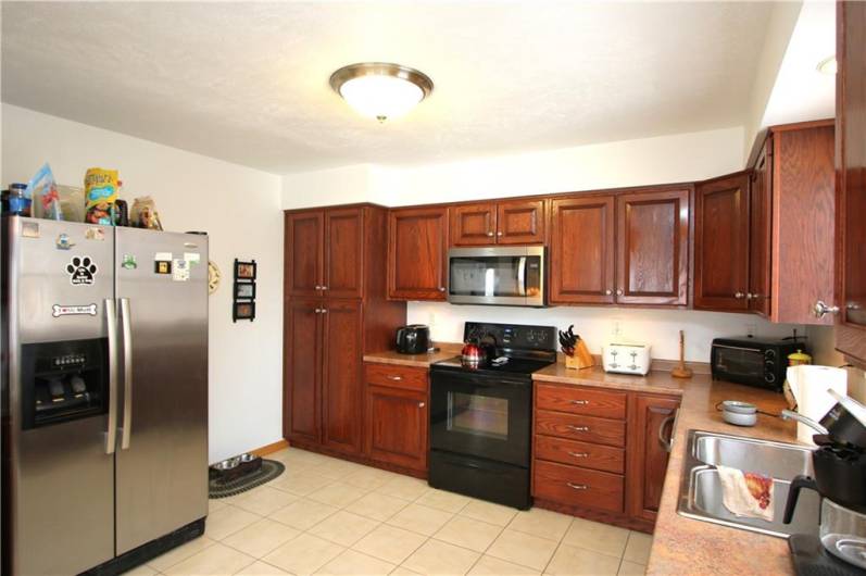 Upgraded Appliance & Lots of Storage Space in Beautiful Cherry Wood Cabinets