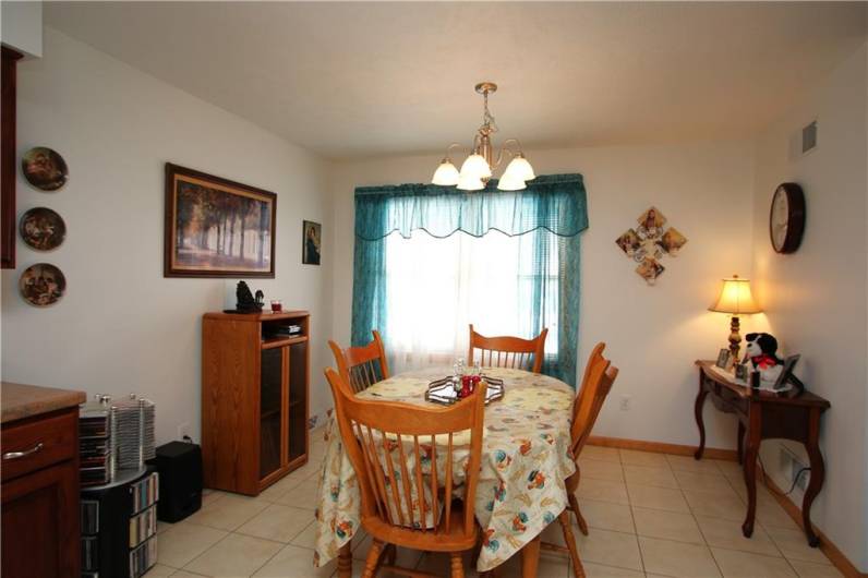 Open Dining area w/ Ceramic Tile Floors, Big Window calling in the Natural Light & Chandelier