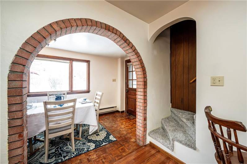 The charming brick entry welcomes you into the dining area.