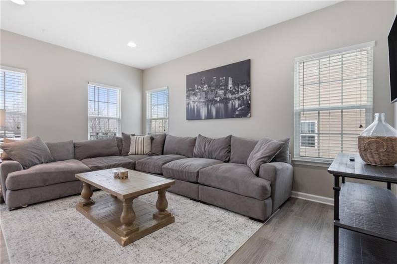 Spread out and enjoy the 21x16 living room/dining room open floor plan with low maintenance luxury vinyl flooring and 9 foot ceilings .