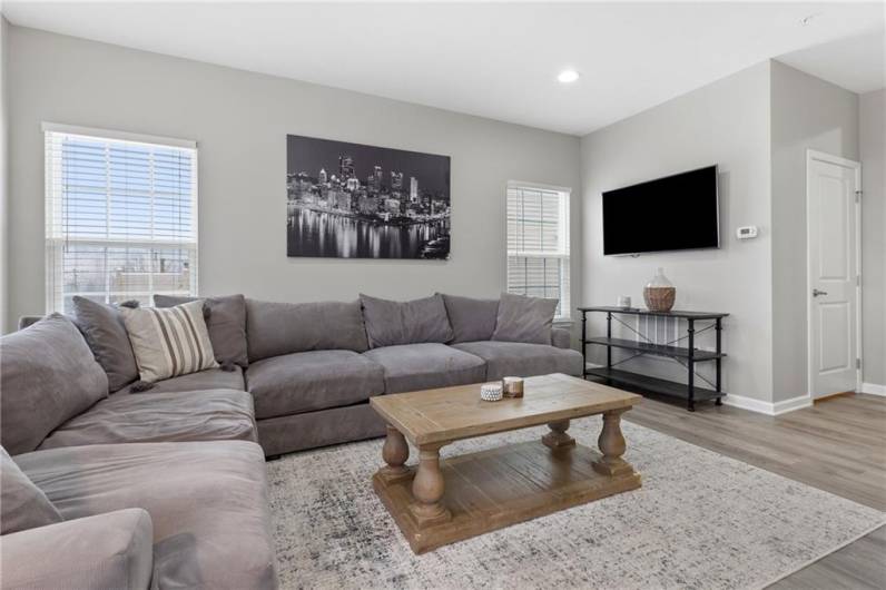 Additional accents include the extensive recessed lighting and the flat screen TV and mount are included.