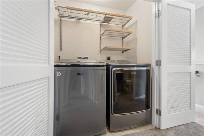 2nd floor 6x3.5 laundry in hallway with included washer and dryer and custom closet shelving.