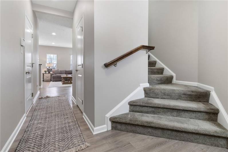 The spacious 19x09 foyer leads to the open floor plan living area and the hall way has a 1st floor powder room and door to garage.