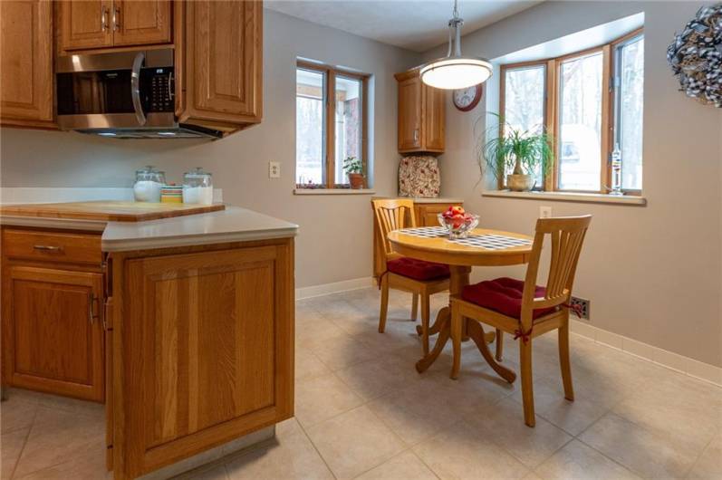 Lovely dinette with bay window.  Cabinets open on both sides plus there's a corner cabinet.