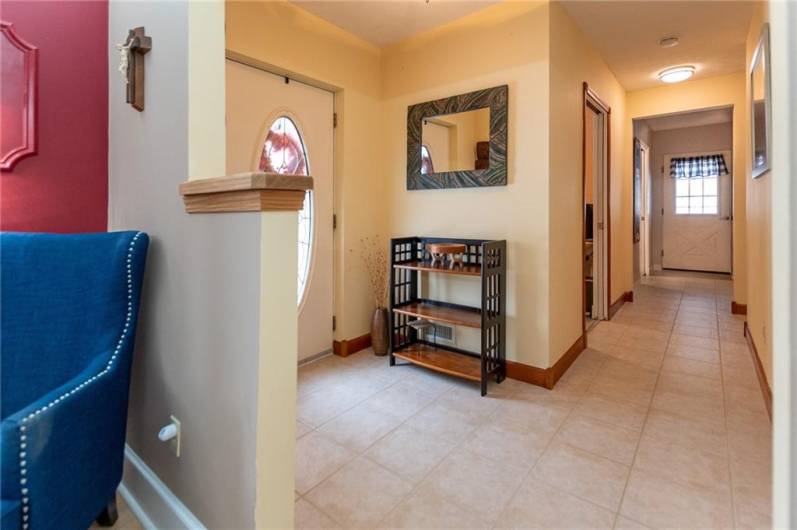 Entryway has good closet space and pristine, regrouted tile flooring that's throughout the kitchen, bath and laundry room.