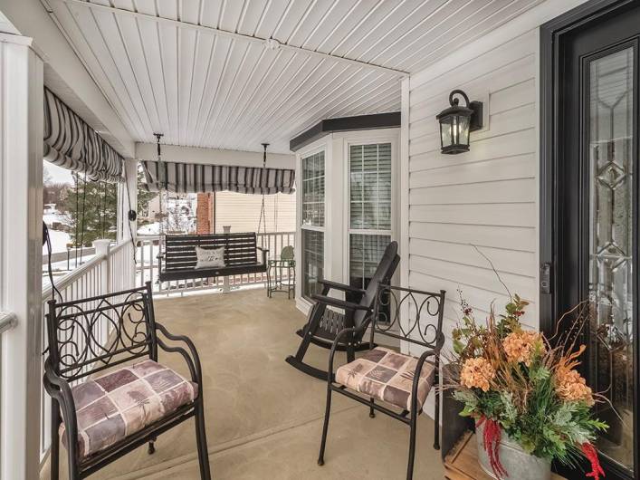 The covered Front Porch with an enchanting swing provides a wonderful place to slow down and catch up with friends.