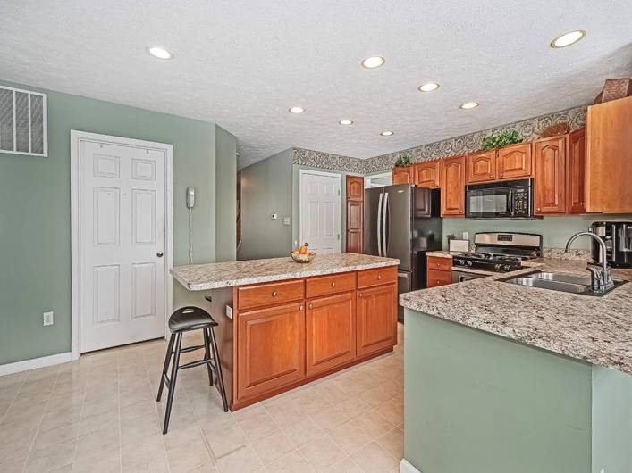 The kitchen cabinets, Island, and additional counter/cabinet, offer an abundance of storage!