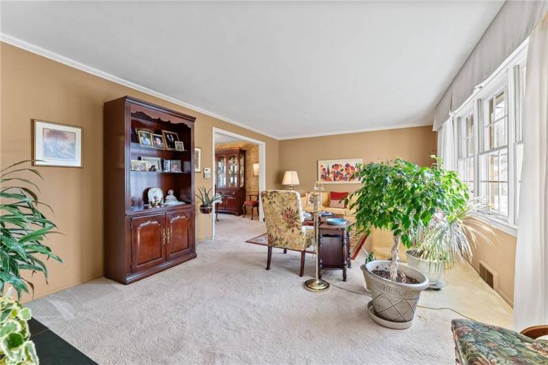 The living room showing access to the dining room to the left.