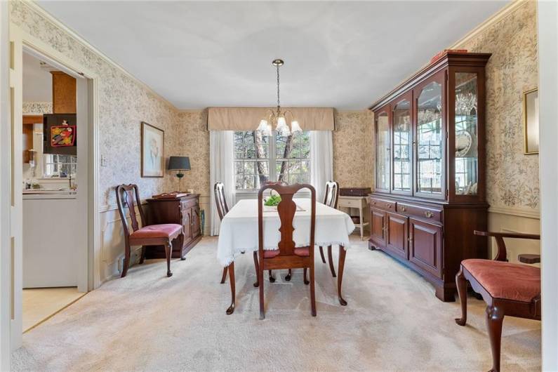 The dining room with access to the kitchen on the left