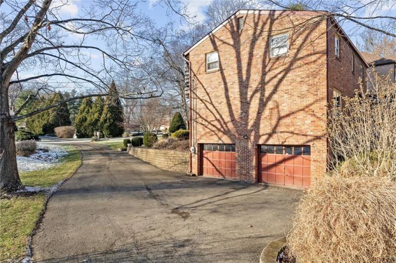 A view of the integral 2 car garage which has been freshly painted and the nice long driveway with plenty of room for parking