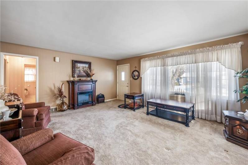 Spacious living room with hardwood floors on the original part of the house.