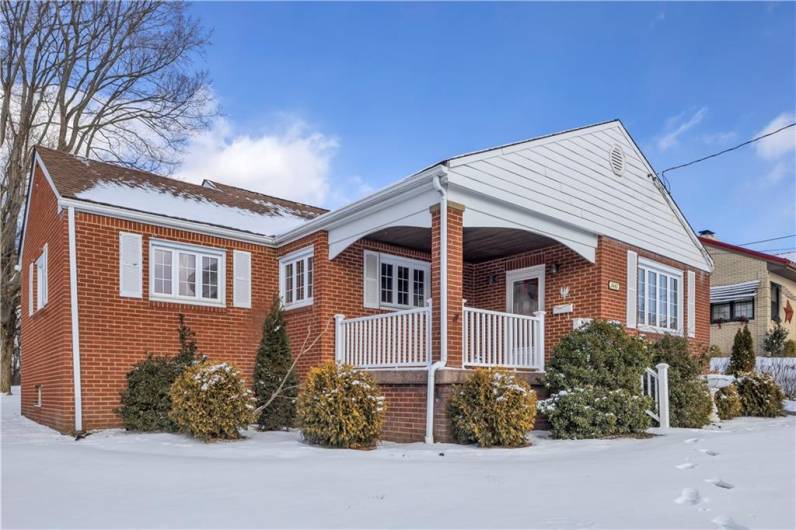 The adorable front porch is the perfect spot to greet family & friends...