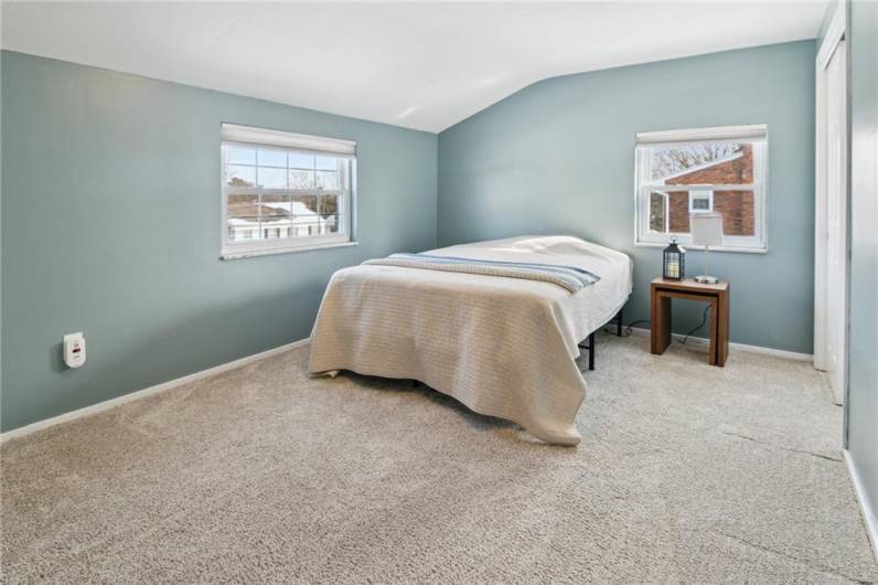 Bedroom 2 with soft neutral colors and ample closet space