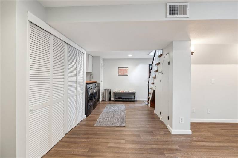 The finished lower level has a handy and stylish laundry station