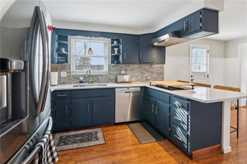 You will love this refreshed kitchen with striking blue cabinetry