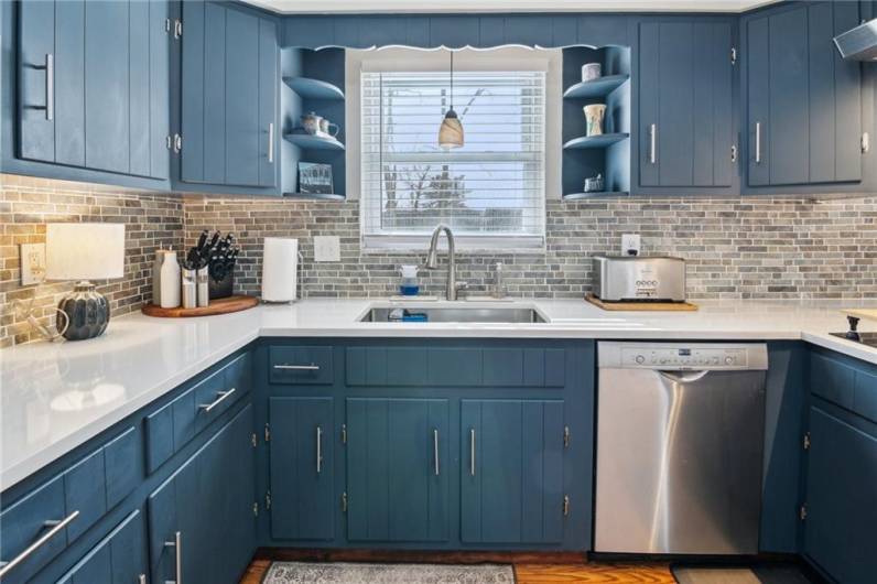 Sleek quartz countertop and a stunning custom backsplash