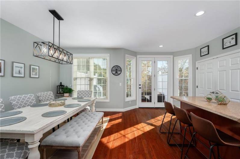 Open Kitchen / Dining area with new windows, new glass door to deck