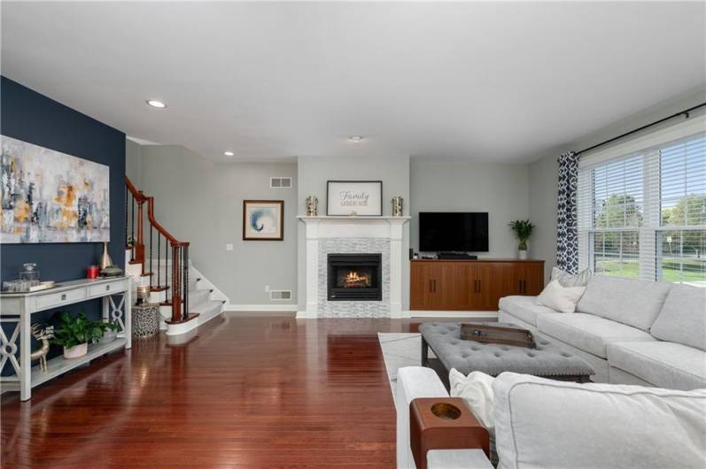 Gorgeous open living area with updated fireplace and built-in cabinetry