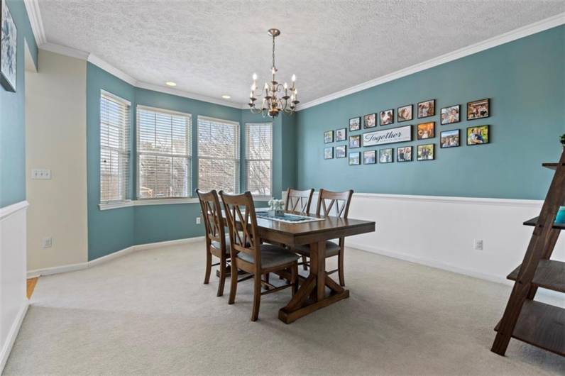 Spacious formal dining room with a beautiful bay window, the perfect setting for family dinners and creating cherished memories around the table.