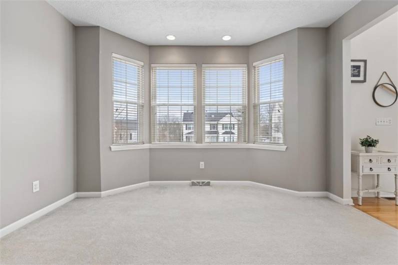 Inviting living room with a charming bay window, a cozy space to relax and enjoy natural light.