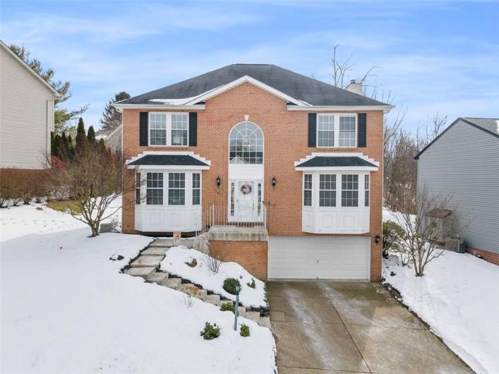 Timeless brick-front elegance with stunning curb appeal!