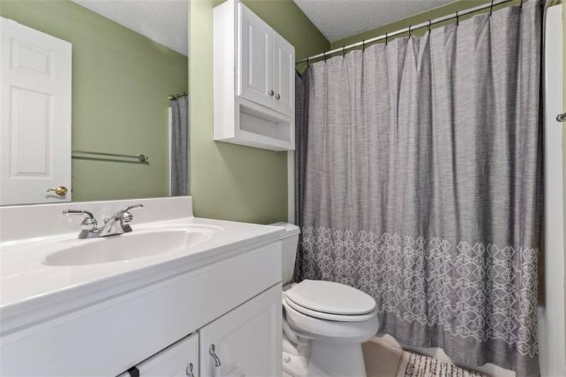 Conveniently located hallway bath, thoughtfully designed for both comfort and ease.