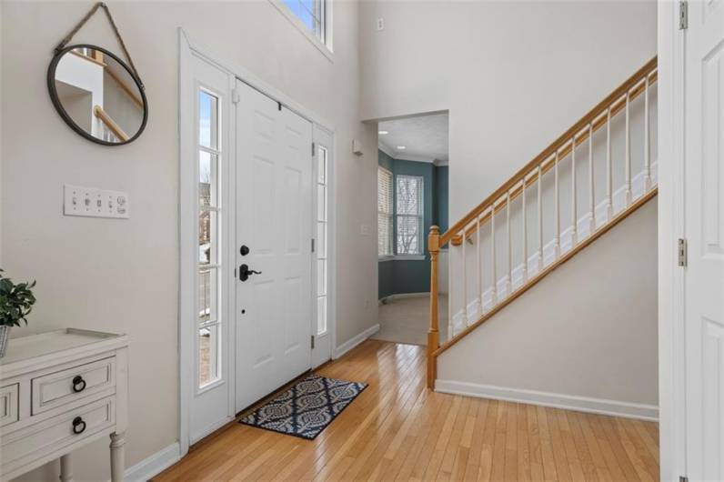 Elegant two-story entrance with gleaming hardwood floors!