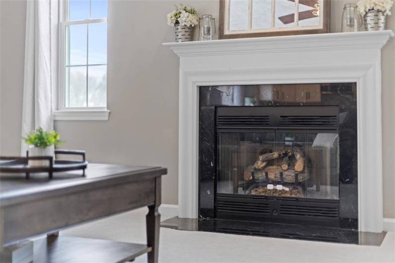 Charming fireplace with a beautiful mantle and trendy surround, adding warmth and character to the heart of the home