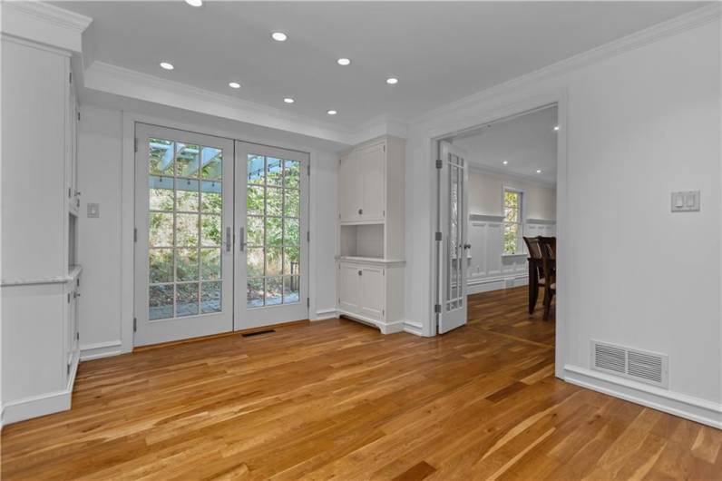 Ideal Breakfast Area with Hardwood Flooring and Charming Built-In Cabinets