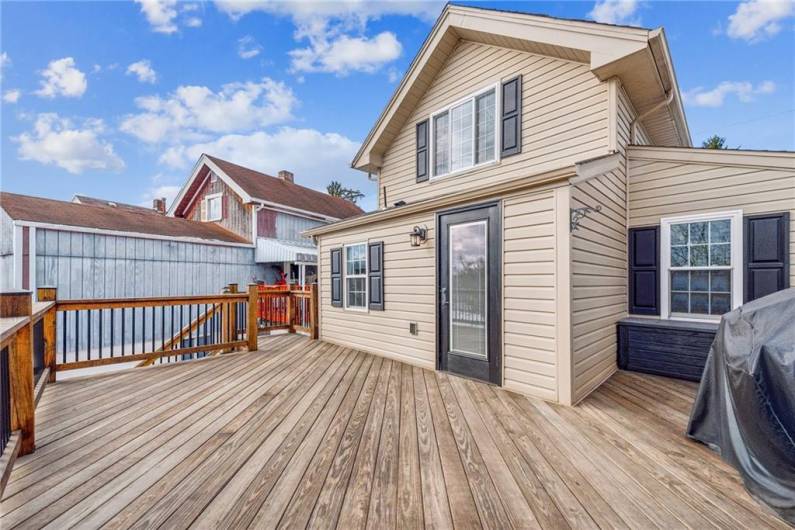 Large deck with steps to lower fenced yard