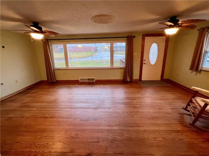 The gleaming hardwoods get tons of natural light from the huge picture window in the living room!