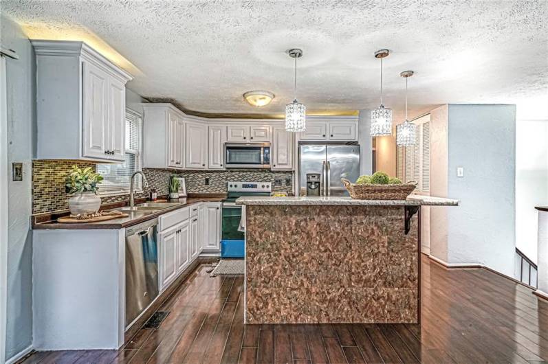 The spacious island serves the heart of the kitchen, offering ample room for meal prep or eating everyday meals.