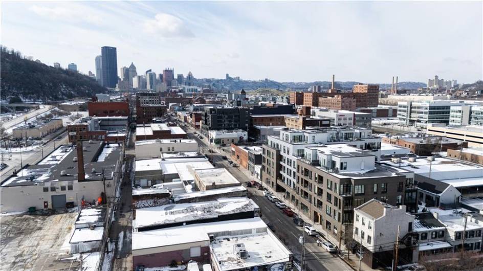 Aerial view, building lower right, downtown in the distance.