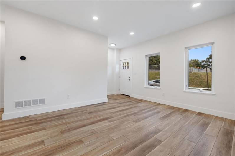 Modern open floor plan on the main level is filled with light