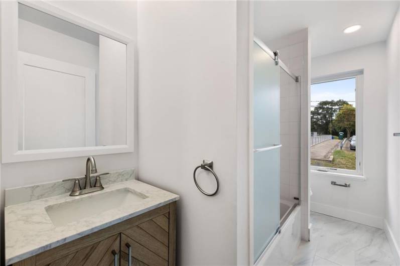 Full bathroom with tub and stylish vanity