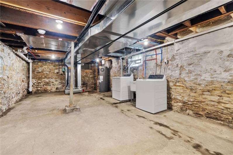 Unfinished basement with new washer and dryer