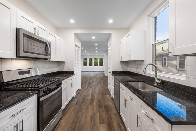 Beautiful kitchen with granite counters, stainless appliances and lots of storage