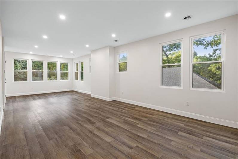 Sunny modern floor plan with lots of windows, recessed lighting and wood-look LTV flooring