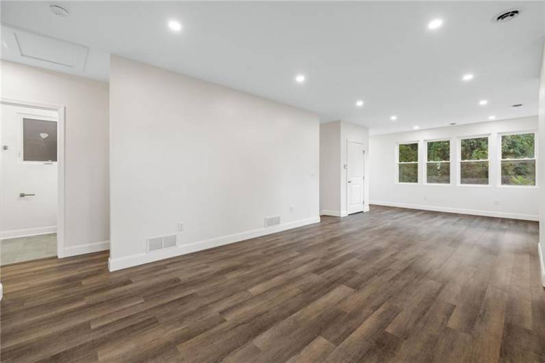 Sunny modern floor plan with lots of windows, recessed lighting and wood-look LTV flooring