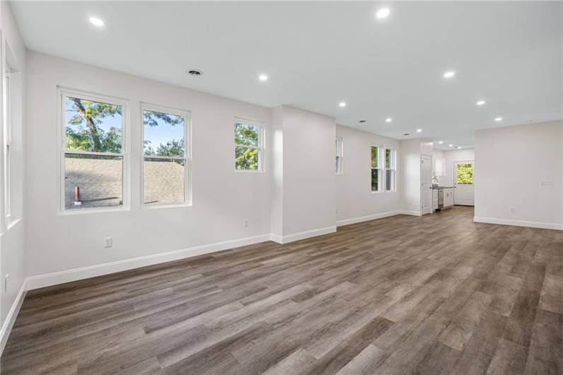 Sunny modern floor plan with lots of windows, recessed lighting and wood-look LTV flooring