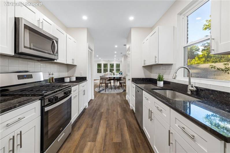 Beautiful kitchen with granite counters, stainless appliances and so much storage space