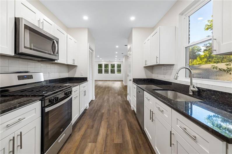 Beautiful kitchen with granite counters, stainless appliances and so much storage space