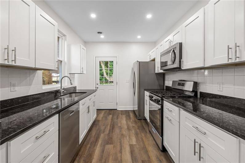 Beautiful kitchen with granite counters, stainless appliances and so much storage space