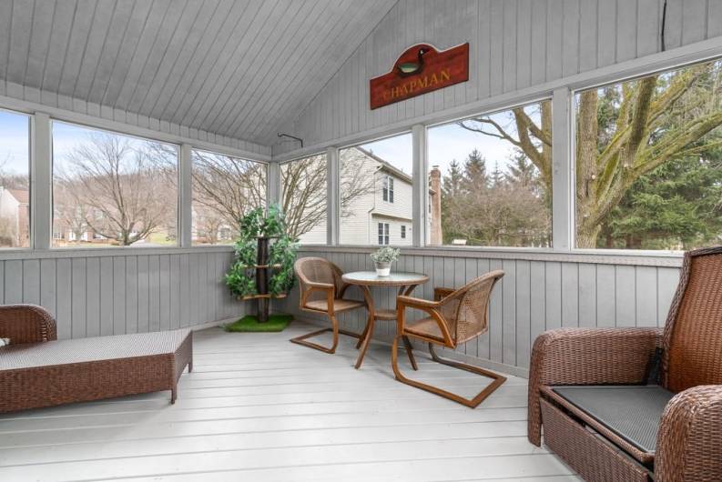 Covered screened porch off of the kitchen which leads to the park-like yard