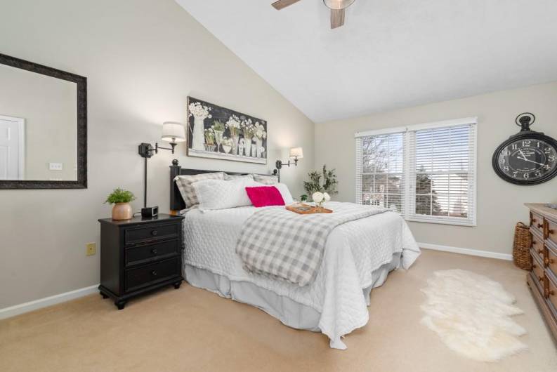 Spacious primary bedroom with vaulted ceilings