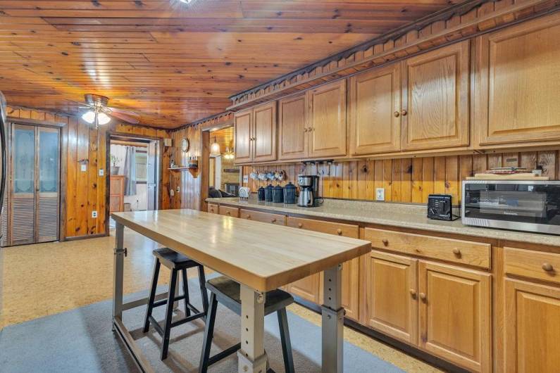 View of kitchen to eat-in breakfast nook, pantry and more built-in storage on entry to dining area.